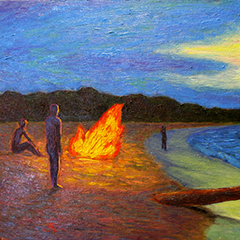 People standing around the beach at sunset.